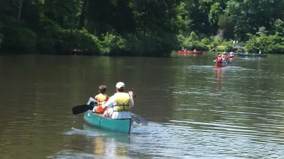 Girl Scouts canoeing on a calm lake