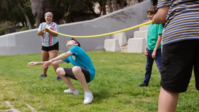 Children playing a limbo game outdoors