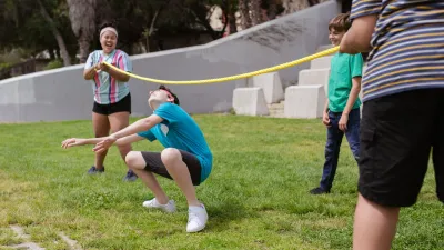 Children playing a limbo game outdoors