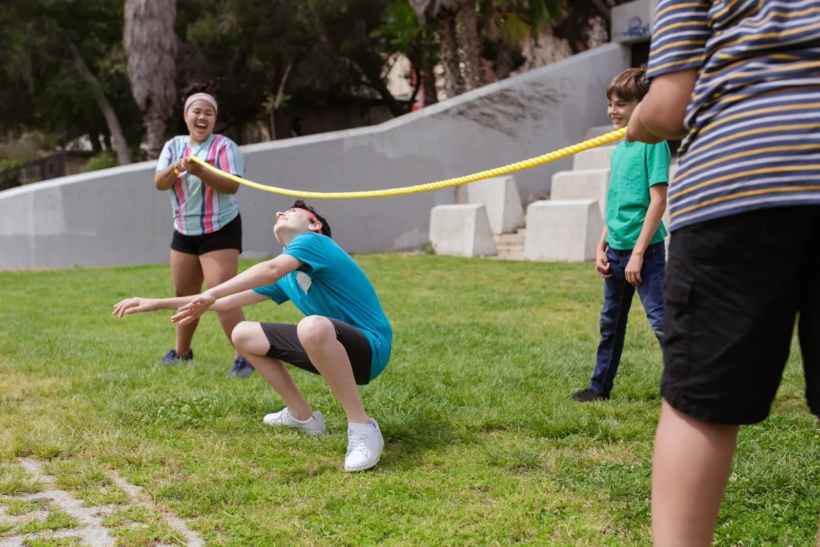 Children playing a limbo game outdoors